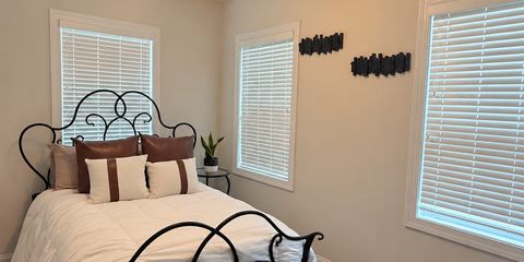 Staged Neutral Bedroom with Scrollwork Bed.png