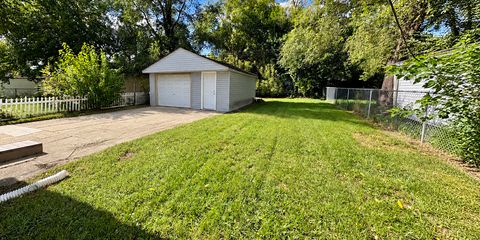 Sunny Suburban Garage and Greenery.png